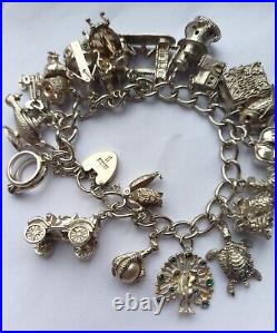 96g. Stunning vintage solid silver charm bracelet & 20 charms, rare, open, move