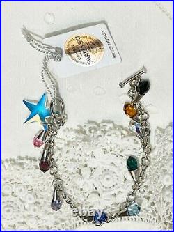 A swarovski crystal sterling silver charm bracelet