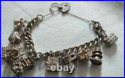 Amazing vintage solid silver chunky charm bracelet & 10 charms. 96g