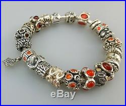 Authentic Pandora silver bracelet with 23 authentic silver charms orange colors