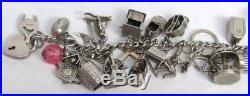 CIRCA 1930's STERLING SILVER CHARM BRACELET WITH 31 ANTIQUE CHARMS