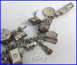 CIRCA 1930's STERLING SILVER CHARM BRACELET WITH 31 ANTIQUE CHARMS