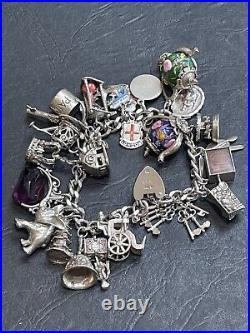 Nice heavy vintage 1967 solid silver charm bracelet with 24 charms