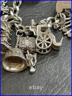 Nice heavy vintage 1967 solid silver charm bracelet with 24 charms