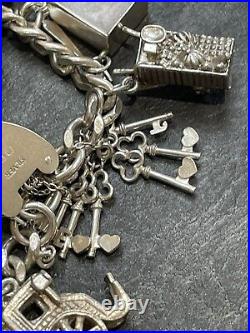 Nice heavy vintage 1967 solid silver charm bracelet with 24 charms