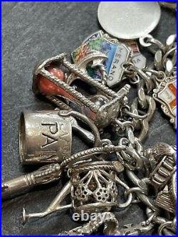 Nice heavy vintage 1967 solid silver charm bracelet with 24 charms