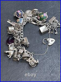 Nice heavy vintage 1967 solid silver charm bracelet with 24 charms