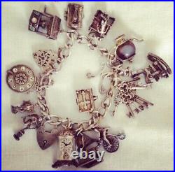 Solid silver vintage charm bracelet from the 1960s /1970s era. 12 charms