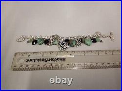 Tested as silver bracelet with silver and stone set charms. Weighs 66gms in total