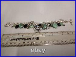 Tested as silver bracelet with silver and stone set charms. Weighs 66gms in total