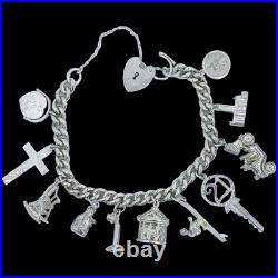 Vintage 1973 sterling silver charm bracelet, 11 charms and heart padlock, bear