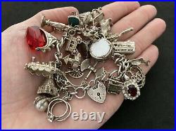 Vintage Sterling Silver Charm Bracelet with 23 Silver Charms. 84 grams
