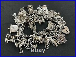 Vintage Sterling Silver Charm Bracelet with 30 Silver Charms. 80 grams