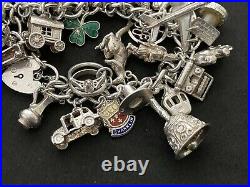 Vintage Sterling Silver Charm Bracelet with 33 Silver Charms. 99 grams