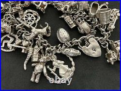 Vintage Sterling Silver Charm Bracelet with 34 Silver Charms. 97 grams