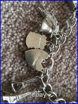 Vintage silver charm bracelet with 16 charms