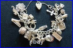 Vintage sterling silver charm bracelet with 26 charms, weight 99g